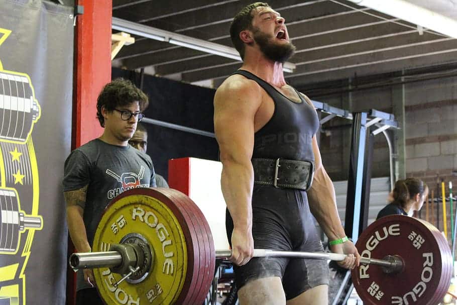 man performing the deadlift in a powerlifting competition