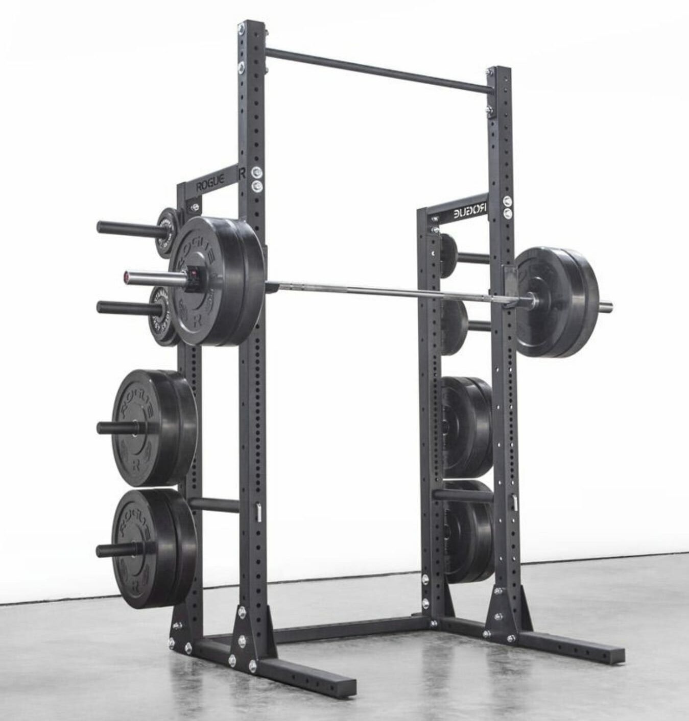 rogue half rack with weights loaded on storage and barbell