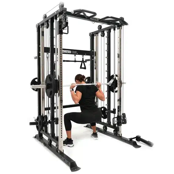 woman doing smith machine squats inside of g3 functional trainer