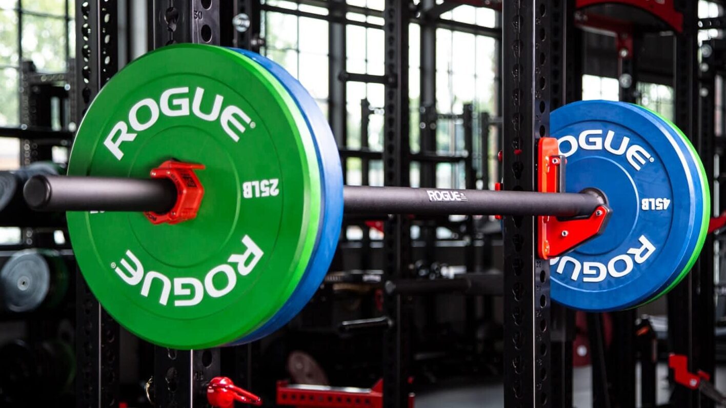 rogue axle/fat bar on a rack with bumper plates loaded