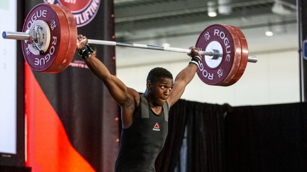 man doing a snatch with rogue weightlifting bar