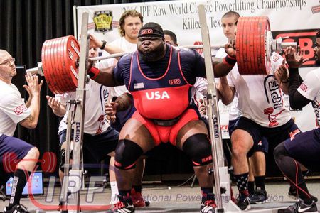 man doing a powerlifting style squat with power bar