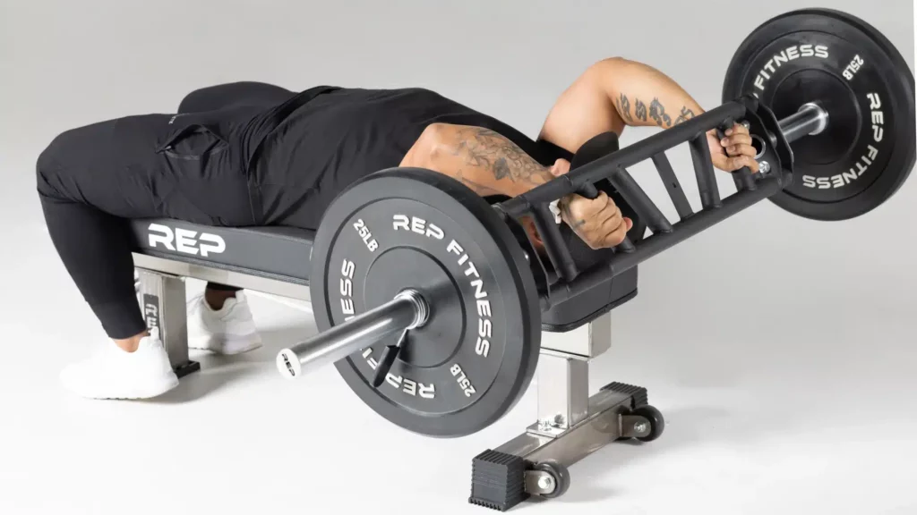 man with tattoos doing extensions with rep fitness cambered swiss bar