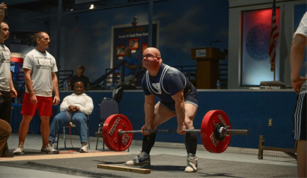 man performing sumo deadlift in powerlifting competition
