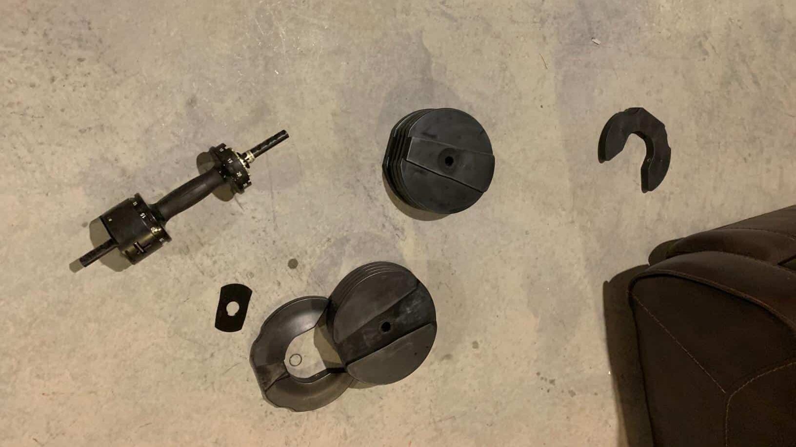 broken core home fitness dumbbell on the ground in pieces
