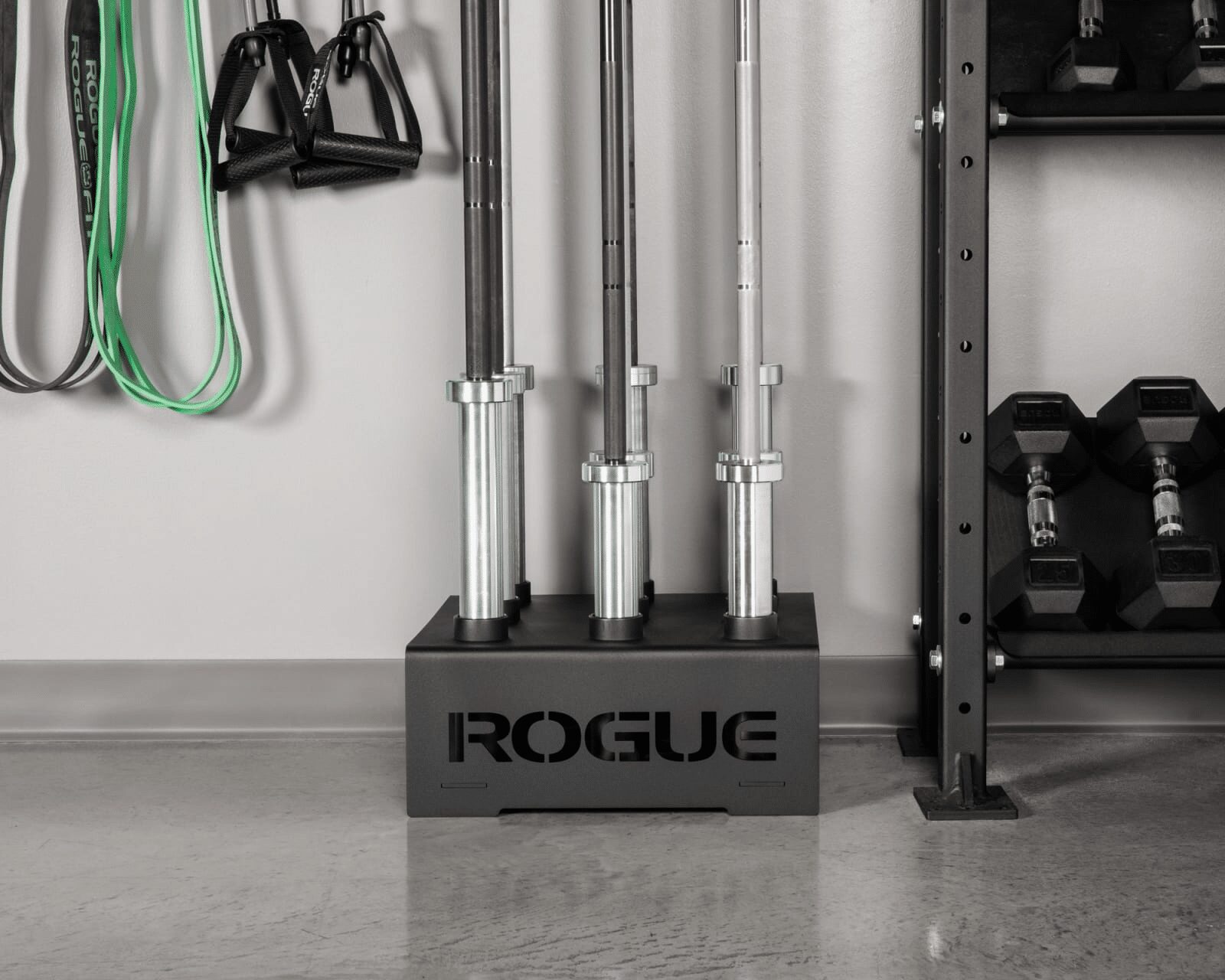 multiple rogue barbells stored in vertical bar holder