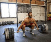 man snatching heavy barbell over his head