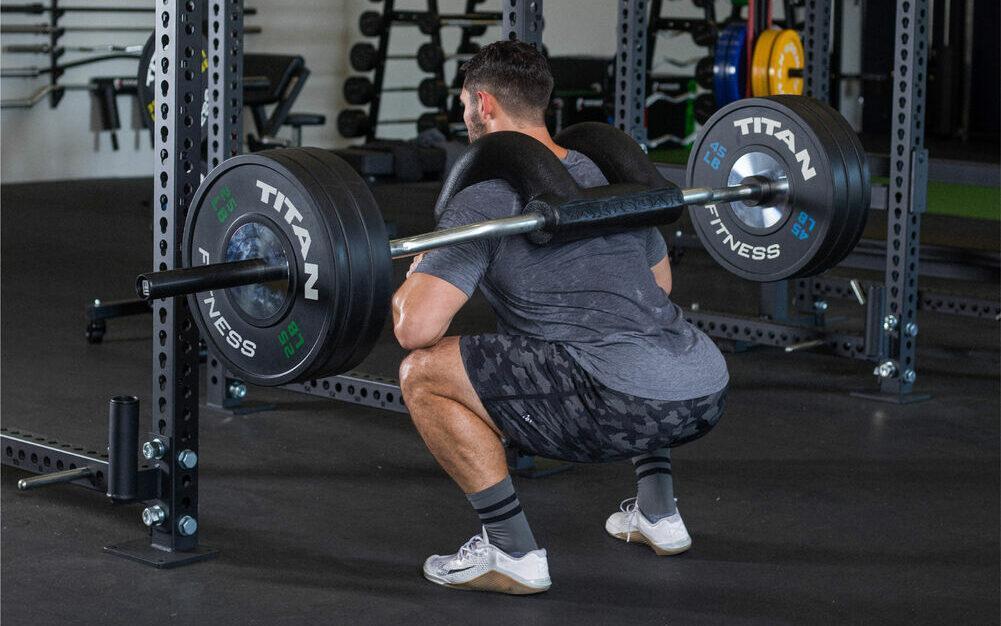 man squatting with the maars bar