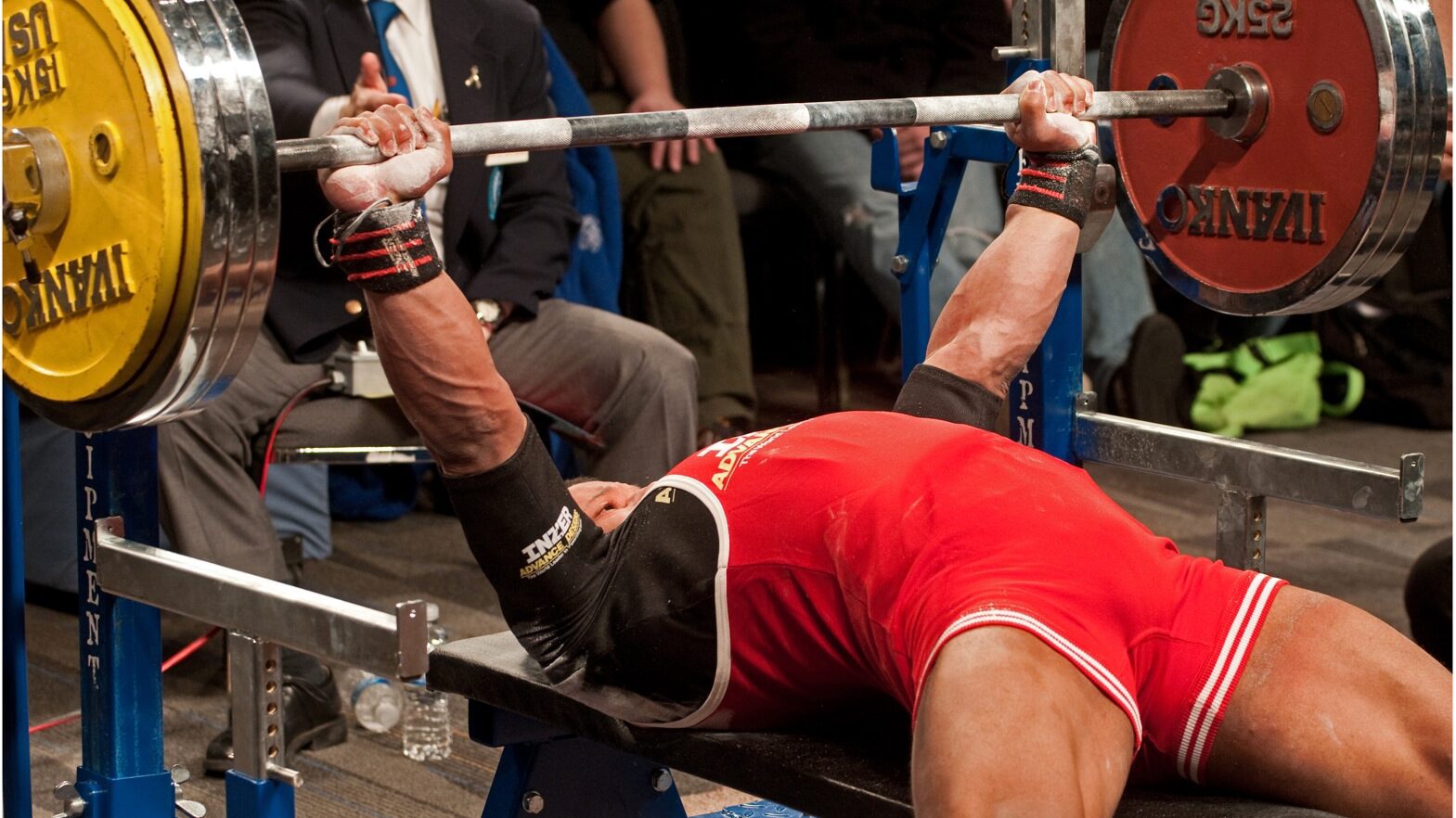 man with a wide grip on the bench press
