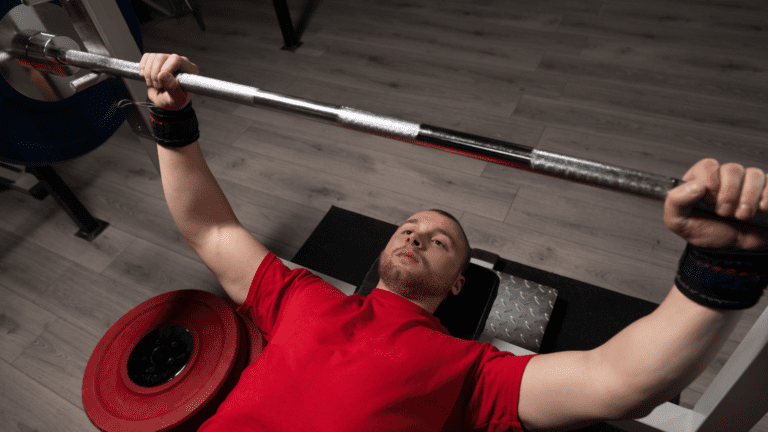 man benching with regular size barbell