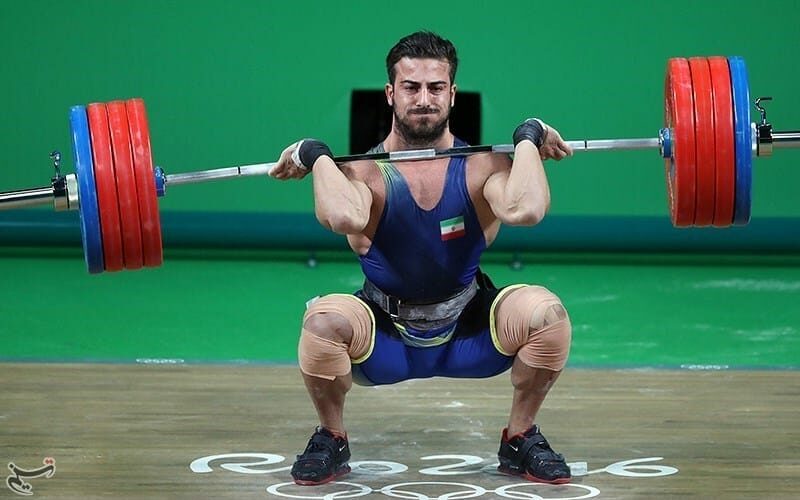man catching a clean with a weightlifting bar