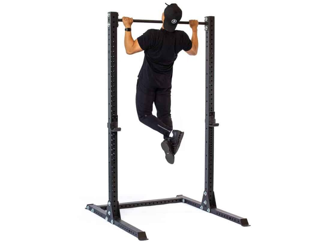 man doing pull ups on a squat stand pull up bar