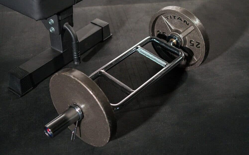 tricep/hammer curl bar next to a weight bench