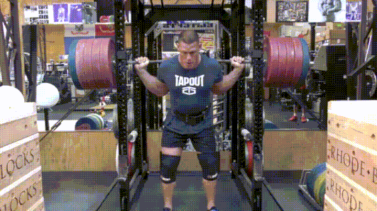 john cena unracking over 500 lb squat and performing the rep with a shout of intensity