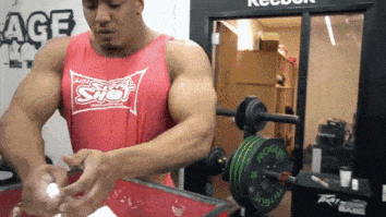 larry wheels chalking up his hands to deadlift big weights